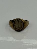 Front view showing JM engraving on oval face