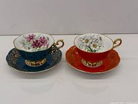 Both cup and saucer sets side by side