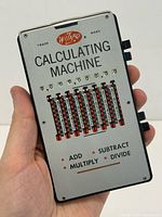 Front view of Wizard calculating machine held in hand