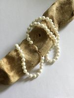 Full necklace coiled showing pearls and clasp