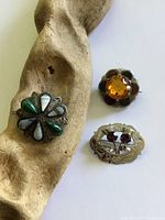 All three brooches displayed on white background