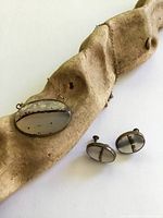 pendant on chain with matching earrings displayed on driftwood