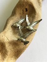 Front view of sterling silver three-bird brooch