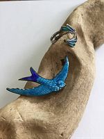 Brooch and ring on driftwood, overall view