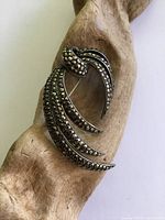 Front view of silver marcasite feather brooch