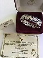 Bracelet in open box with certificate and booklet visible