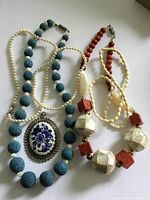 Overview of all four necklaces showing beads, pendant and clasps