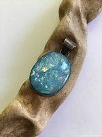Front view showing crushed blue opal side and silver bezel