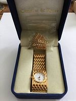 Watch in box showing bracelet and dial