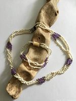 Necklace and bracelet coiled together showing full strand design