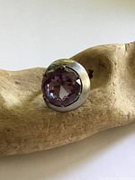 Front view of sterling silver ring with large purple faceted stone