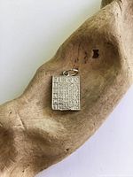 Front view of sterling bingo card pendant showing design and bail