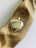 Front view of sterling silver heart locket showing etched design