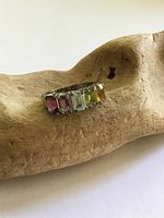 Front view of sterling silver ring showing five coloured baguette gemstones