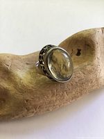 Top view showing oval quartz cabochon and cut-out lettering bezel