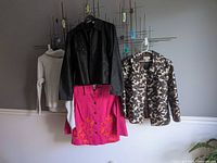 Group shot of four garments on hangers