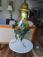 Full view of amber glass dispenser on stand