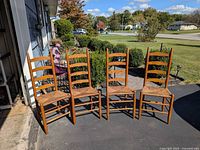 Front view of four ladder-back chairs lined up