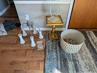 Group shot of chandelier, table, candle holder, and drum shade