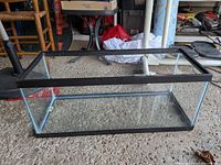 Side view of rectangular glass aquarium with black plastic frame