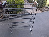 Front view of five-tier metal and plastic shoe rack
