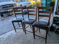 All three wooden counter-height chairs together