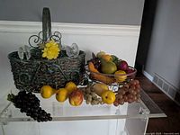Overall view: wicker basket, wire basket with fruit, additional fruit in front