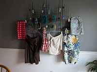 Six garments hung on rack showing variety of prints and colors
