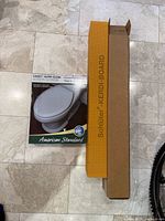 American Standard toilet seat box beside Schluter Kerdi-Board curb box