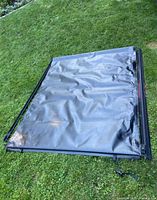 Full view of rolled tonneau cover with rails