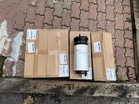 Three carton boxes with one air suspension bag displayed on top