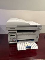 Front view of Pantum M6559NW printer showing control panel and paper tray
