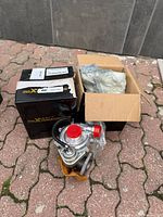 Two maXpeedingRODS boxes with one turbocharger in front showing wastegate actuator and red caps