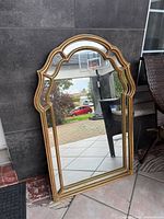 Front view showing gold frame and arched shape