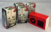 Three KIG Group boxes of glass candle holders alongside Stelton box