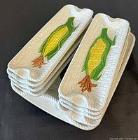 Stacked corn-on-the-cob dishes on tray