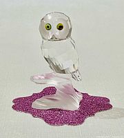 Front view showing owl’s eyes, faceted body, frosted branch base