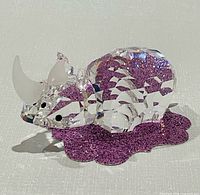 Front side view of clear Swarovski crystal rhinoceros showing horn and body facets