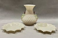 Vase centered between two trinket dishes