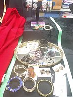 Overview of jewellery on table showing bracelets, ring, earrings