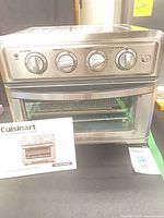 Front view of Cuisinart AirFryer Toaster Oven with manual displayed