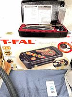 Overall lot showing T-FAL grill box and Hamilton Beach knife case