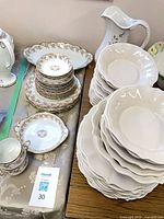 Bone china and stoneware stacks with Haeger pitcher in background