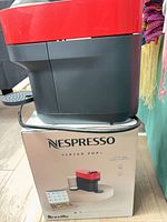 Nespresso Vertuo Pop+ machine sitting on box