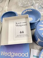 Plaque partly visible with white relief, box, leaflet