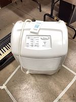 Top view of Whirlpool dehumidifier showing control panel, grille and power cord