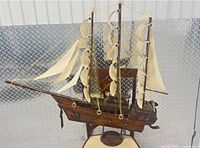 Overall view of wooden sailing ship model with sails and rigging