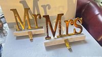 Front view of both Mr and Mrs towel holders showing gold letters and marble bases