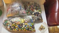 Multiple clear bags filled with assorted beads on table