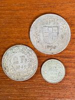 Obverse and reverse of all three coins showing denomination and dates
